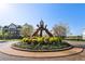 A beautiful roundabout with greenery and an artistic metal structure at 933 Catamaran Ct, Alpharetta, GA 30005