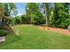 Large backyard with lush green lawn and stepping stones leading to a secluded area at 1154 Pair Sw Rd, Marietta, GA 30060
