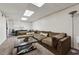 Basement living area with sectional sofa, plush carpet, and modern lighting at 1154 Pair Sw Rd, Marietta, GA 30060
