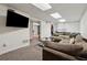 Basement rec room with large sectional sofa, television, and a view to backyard at 1154 Pair Sw Rd, Marietta, GA 30060