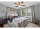 Well-lit bedroom with bright walls, a large window, and decorative sconces at 1154 Pair Sw Rd, Marietta, GA 30060