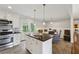 Bright eat-in kitchen features a central island, stainless appliances, and backyard access at 1154 Pair Sw Rd, Marietta, GA 30060