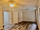 Spacious bedroom featuring modern wood-look floors, a ceiling fan, and bright white trim throughout at 3211 Oaktree Park Dr, Lawrenceville, GA 30044