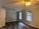 Charming bedroom with wood-look flooring, neutral walls, bright white trim, and a ceiling fan at 3211 Oaktree Park Dr, Lawrenceville, GA 30044