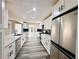 Spacious kitchen featuring stainless steel appliances, white cabinets, and a large countertop at 3211 Oaktree Park Dr, Lawrenceville, GA 30044