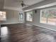 Bright living room with wood-look floors, multiple windows offering lots of natural light, and neutral paint at 3211 Oaktree Park Dr, Lawrenceville, GA 30044