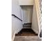 Well-lit staircase with dark wood steps and white railings leading to the upper level of the home at 3211 Oaktree Park Dr, Lawrenceville, GA 30044