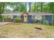 Charming blue brick home with a sunny yellow door, complemented by a well-maintained front yard at 3901 Bonnie Se Ln, Atlanta, GA 30354