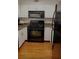 Cozy kitchen featuring black appliances, granite countertops and light hardwood floors at 2479 Peachtree Rd # 503, Atlanta, GA 30305