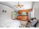 Open apartment layout with a mini kitchen, stainless steel appliances, breakfast bar, bed, and hardwood floors at 2580 Acorn Ne Ave, Atlanta, GA 30305