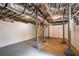 Exposed basement with support beams and a concrete floor presents an opportunity for customization at 2580 Acorn Ne Ave, Atlanta, GA 30305