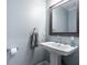 Bathroom with a pedestal sink and framed mirror provides a clean and simple aesthetic at 2580 Acorn Ne Ave, Atlanta, GA 30305