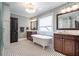 Stylish bathroom with a freestanding tub, dual vanities, elegant fixtures, and classic black and white tile at 2580 Acorn Ne Ave, Atlanta, GA 30305
