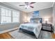 Well-lit bedroom with a comfortable bed, matching nightstands, and a ceiling fan at 2580 Acorn Ne Ave, Atlanta, GA 30305