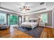 Bright bedroom with tray ceilings, hardwood floors, access to private balcony, and neutral color palette at 2580 Acorn Ne Ave, Atlanta, GA 30305