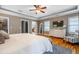 This bedroom features a TV, dresser, ceiling fan, hardwood floors, and an ensuite bathroom at 2580 Acorn Ne Ave, Atlanta, GA 30305
