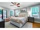 Bedroom featuring a ceiling fan, multiple windows, a sitting area, and hardwood floors at 2580 Acorn Ne Ave, Atlanta, GA 30305