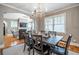 Cozy dining room with dark wood table, chairs, decorative chandelier, and entry to the living room at 2580 Acorn Ne Ave, Atlanta, GA 30305
