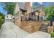 Brick home showcasing a backyard entrance with steps, a balcony, and a detached two-car garage at 2580 Acorn Ne Ave, Atlanta, GA 30305