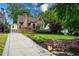 Charming brick home with a manicured lawn, quaint front porch, and a long driveway at 2580 Acorn Ne Ave, Atlanta, GA 30305