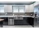 Kitchen with shaker cabinets, stainless appliances, grey backsplash, and a farmhouse sink at 2580 Acorn Ne Ave, Atlanta, GA 30305