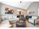 Open-concept living room featuring a vaulted ceiling that flows into dining area with an elegant chandelier at 2580 Acorn Ne Ave, Atlanta, GA 30305