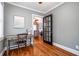 Cozy office with hardwood floors, a desk, a window, and a glass door leading to the living area at 2580 Acorn Ne Ave, Atlanta, GA 30305