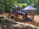Colorful playground with slides, tunnels, and climbing structures in a wooded setting at 2580 Acorn Ne Ave, Atlanta, GA 30305