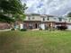 Townhome backyard featuring a patio and green lawn at 3871 Pleasant Oaks Dr, Lawrenceville, GA 30044