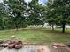 View of the spacious backyard with mature trees at 3871 Pleasant Oaks Dr, Lawrenceville, GA 30044