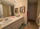 Bathroom featuring double sinks, a large mirror, and tiled floors at 3871 Pleasant Oaks Dr, Lawrenceville, GA 30044