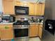 Kitchen features stainless steel appliances and wooden cabinetry at 3871 Pleasant Oaks Dr, Lawrenceville, GA 30044
