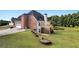 Spacious backyard with a deck, patio, and landscaped garden beds at 400 Kyle Ct, Fayetteville, GA 30215