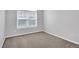 Bedroom with neutral carpet and a large window at 400 Kyle Ct, Fayetteville, GA 30215