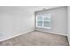 Bedroom featuring neutral carpet and a large window at 400 Kyle Ct, Fayetteville, GA 30215