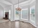 Sun-filled dining area with chandelier, windows, and access to the backyard at 400 Kyle Ct, Fayetteville, GA 30215