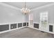Elegant dining room with wainscoting, chandelier, and natural light at 400 Kyle Ct, Fayetteville, GA 30215