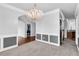 Elegant dining room with stylish chandelier, chair railing, and access to other rooms at 400 Kyle Ct, Fayetteville, GA 30215