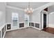 Light-filled dining room with wainscoting, chandelier, and large windows at 400 Kyle Ct, Fayetteville, GA 30215