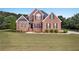 Well-maintained brick home on a large lot with a green lawn and neat landscaping at 400 Kyle Ct, Fayetteville, GA 30215