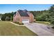 Brick home featuring a two car garage and well-kept landscaping at 400 Kyle Ct, Fayetteville, GA 30215