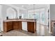 Efficient kitchen with wood cabinets, tile flooring, and connection to dining space at 400 Kyle Ct, Fayetteville, GA 30215