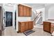 Kitchen featuring wooden cabinets and access to the staircase at 400 Kyle Ct, Fayetteville, GA 30215