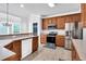 Well-lit kitchen featuring wooden cabinets and stainless steel appliances at 400 Kyle Ct, Fayetteville, GA 30215