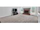 Cozy living room with brick fireplace, neutral carpet, and natural light at 400 Kyle Ct, Fayetteville, GA 30215