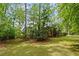 Expansive backyard featuring a lush lawn surrounded by mature trees, offering a private outdoor space at 681 Hampton Sw Pl, Marietta, GA 30064