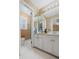 Well-lit bathroom with white cabinets, patterned wallpaper, and hexagon tile flooring at 681 Hampton Sw Pl, Marietta, GA 30064