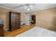 Neutral bedroom with hardwood floors, large bed, armoire, and ample closet space at 681 Hampton Sw Pl, Marietta, GA 30064