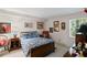 Cozy bedroom featuring a wood-framed bed with blue floral bedding, complemented by vintage decor and natural light at 681 Hampton Sw Pl, Marietta, GA 30064