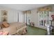 Well-lit bedroom with floral accents, plantation shutters and neutral walls at 681 Hampton Sw Pl, Marietta, GA 30064